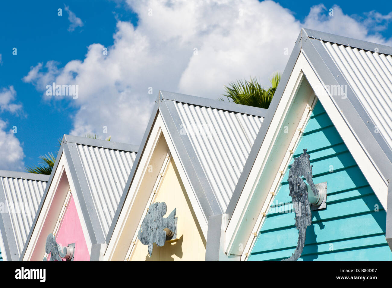 Pastel gables decorated with nautical symbols against deep blue sky with white clouds Stock Photo