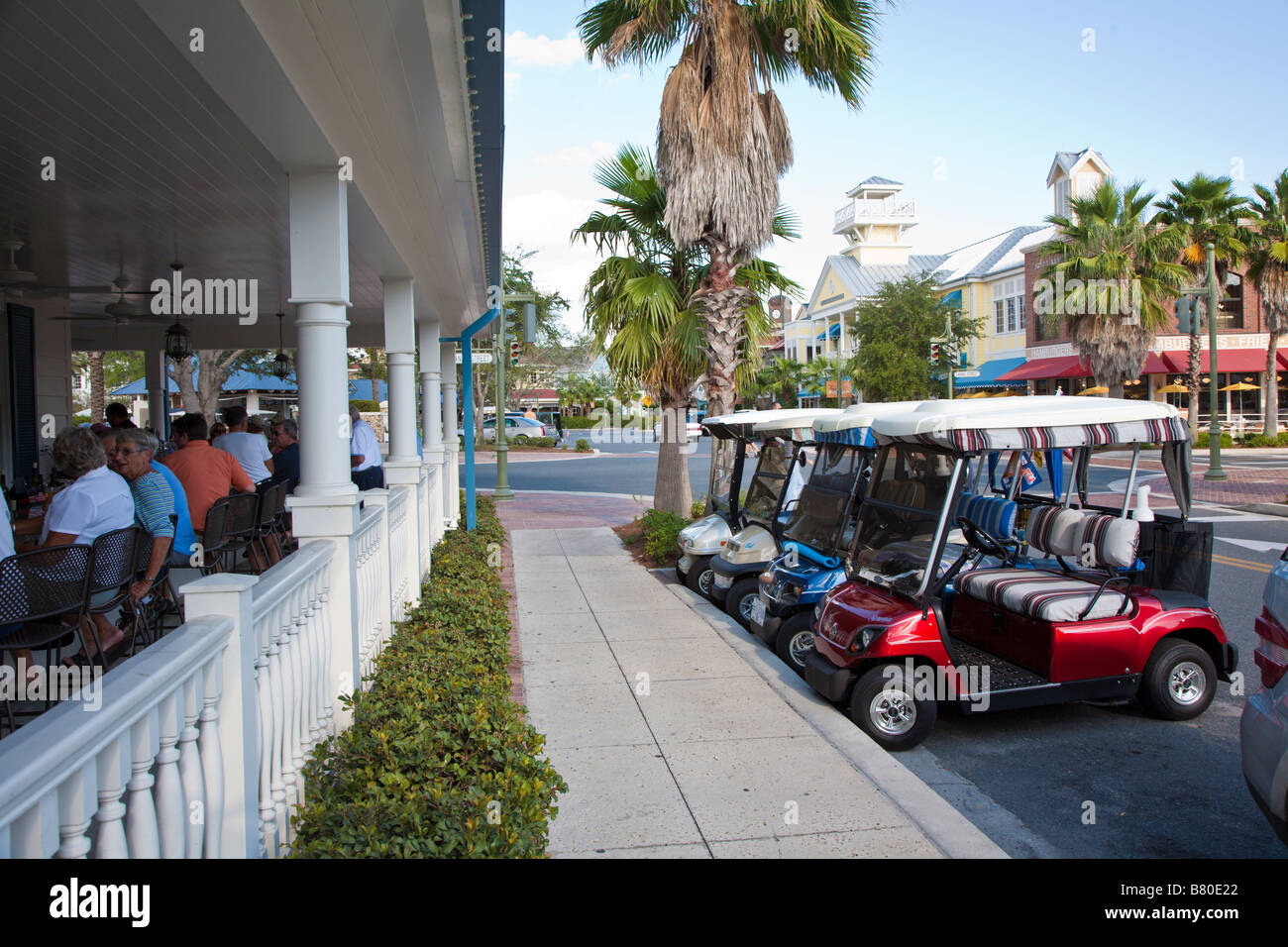 Golf carts lined up at the curb of a local outdoor bar in The Villages retirement community in Central Florida, USA Stock Photo