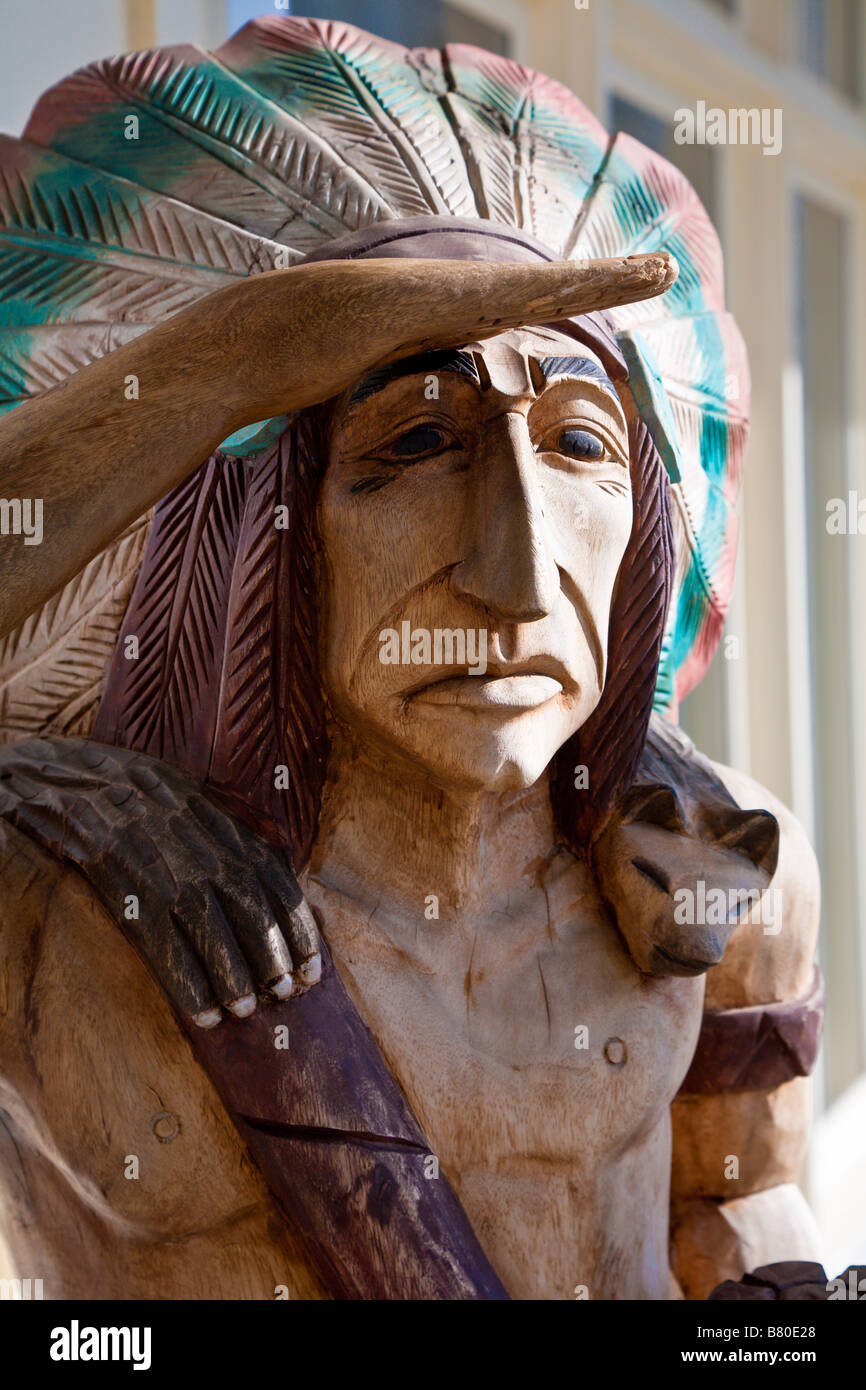 Carved wooden statue of American Indian outside tobacco store in The Villages of Lady Lake, Florida, USA Stock Photo