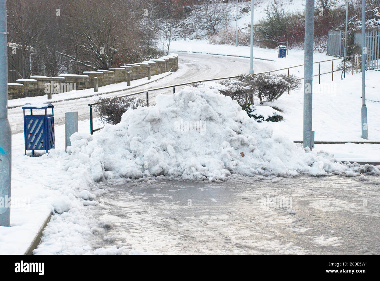 A pile of cleared snow in a car park. Stock Photo