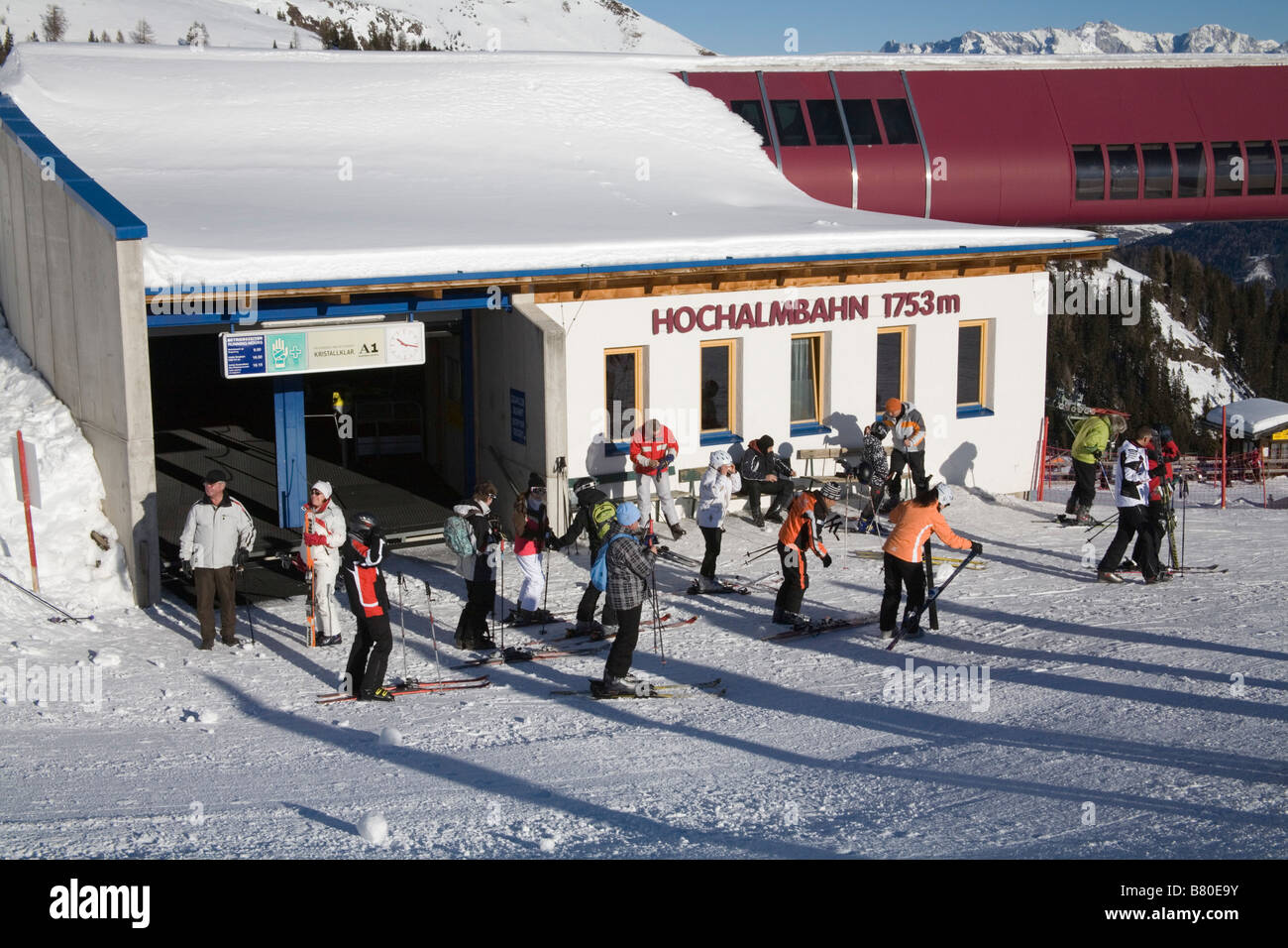 Rauris Austria EU January Skiers exiting the Hochalmbahn gondola station onto the ski slopes Stock Photo