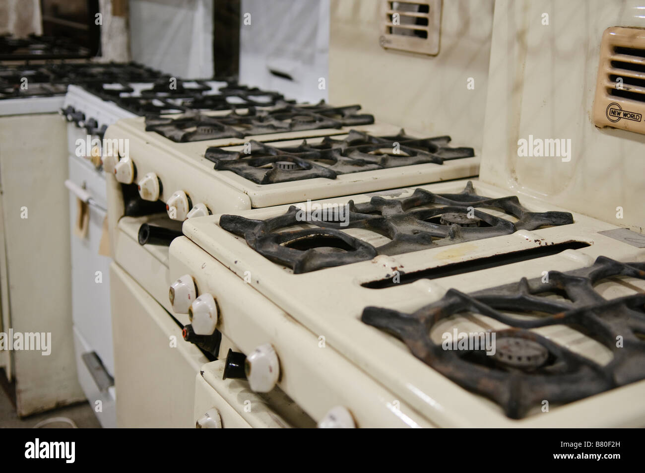 Old gas cookers from the 1950s, 1960s and 1970s lined up in Flame Gasworks Museum of Ireland. Stock Photo
