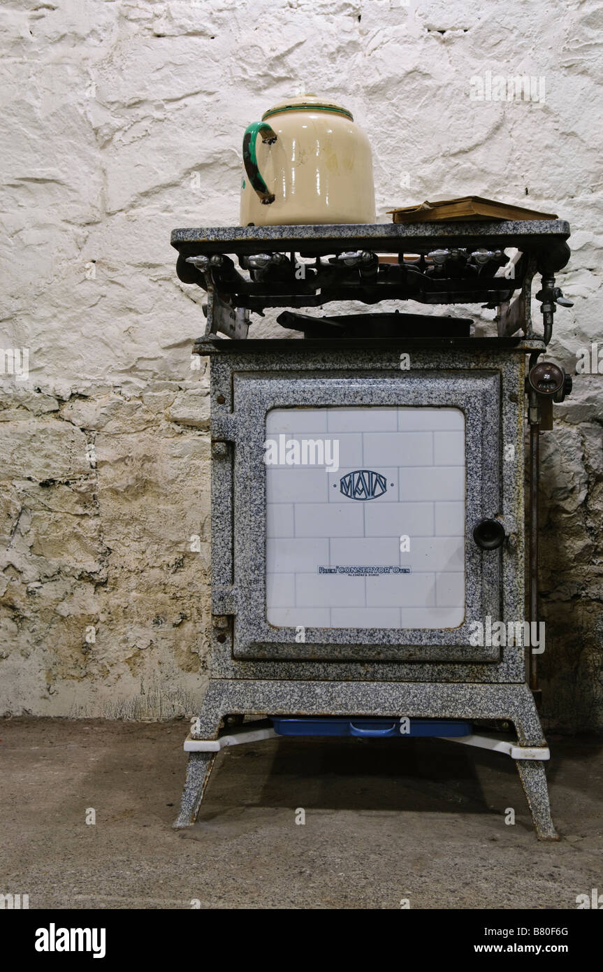 Cast iron gas oven/cooker from c1900-1920 with enameled kettle on hob Stock Photo