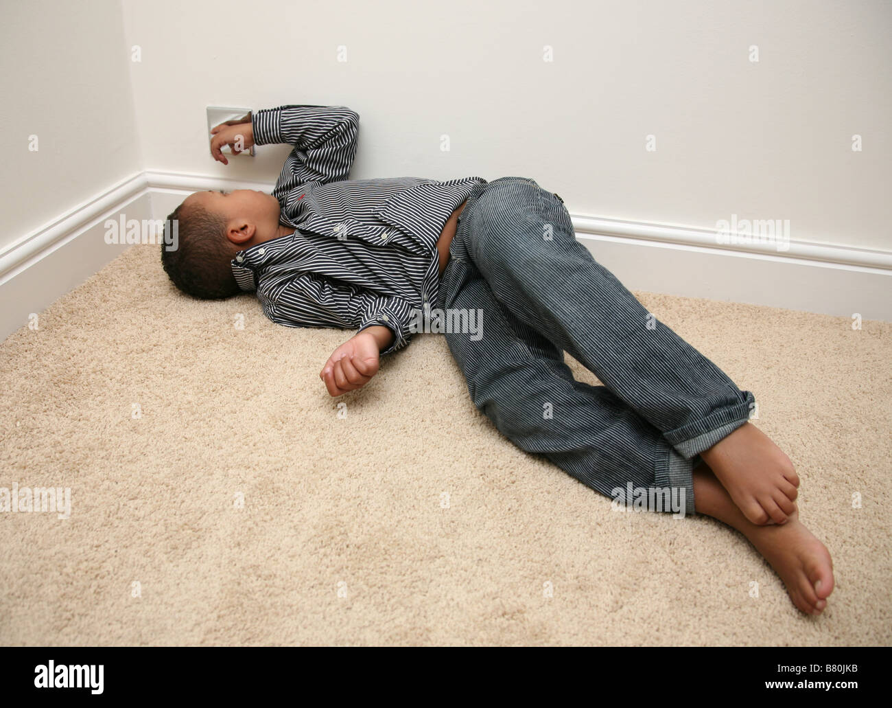 5 year old boy having a tantrum and sulking Stock Photo