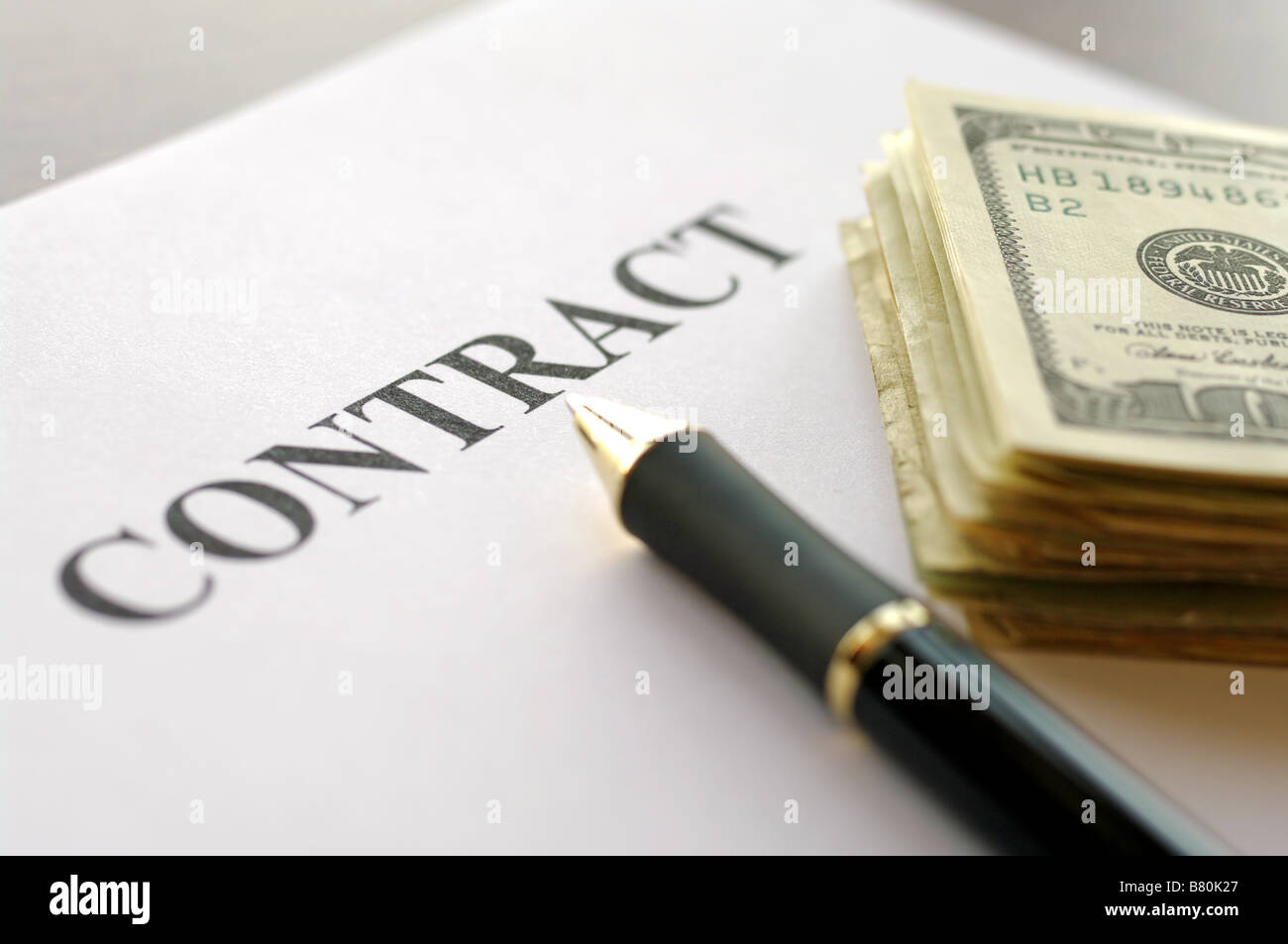 Pen and dollars on contract paper Stock Photo