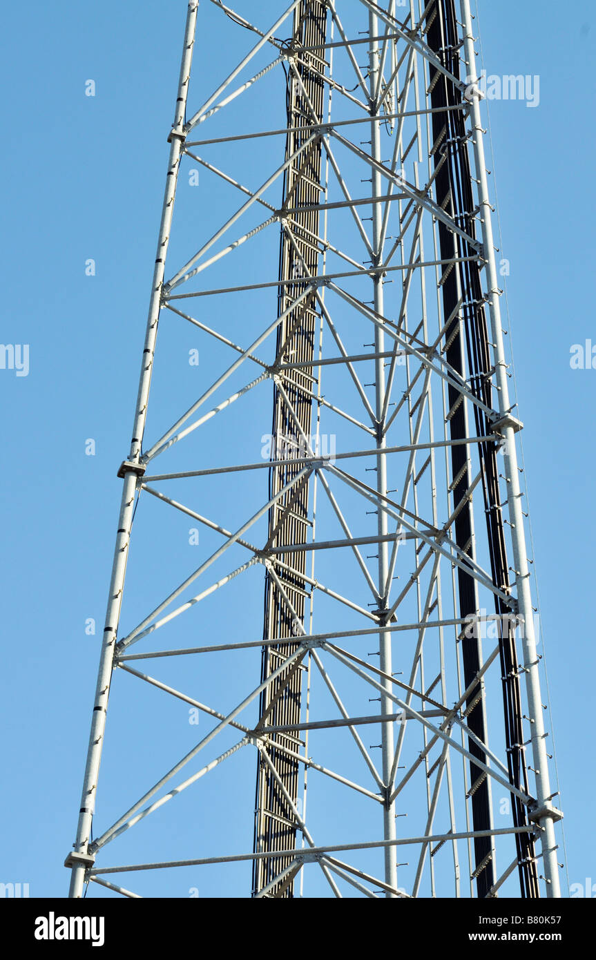 Close up of a cell mobile phone communications tower showing wire cables ladder and graphic angles Stock Photo