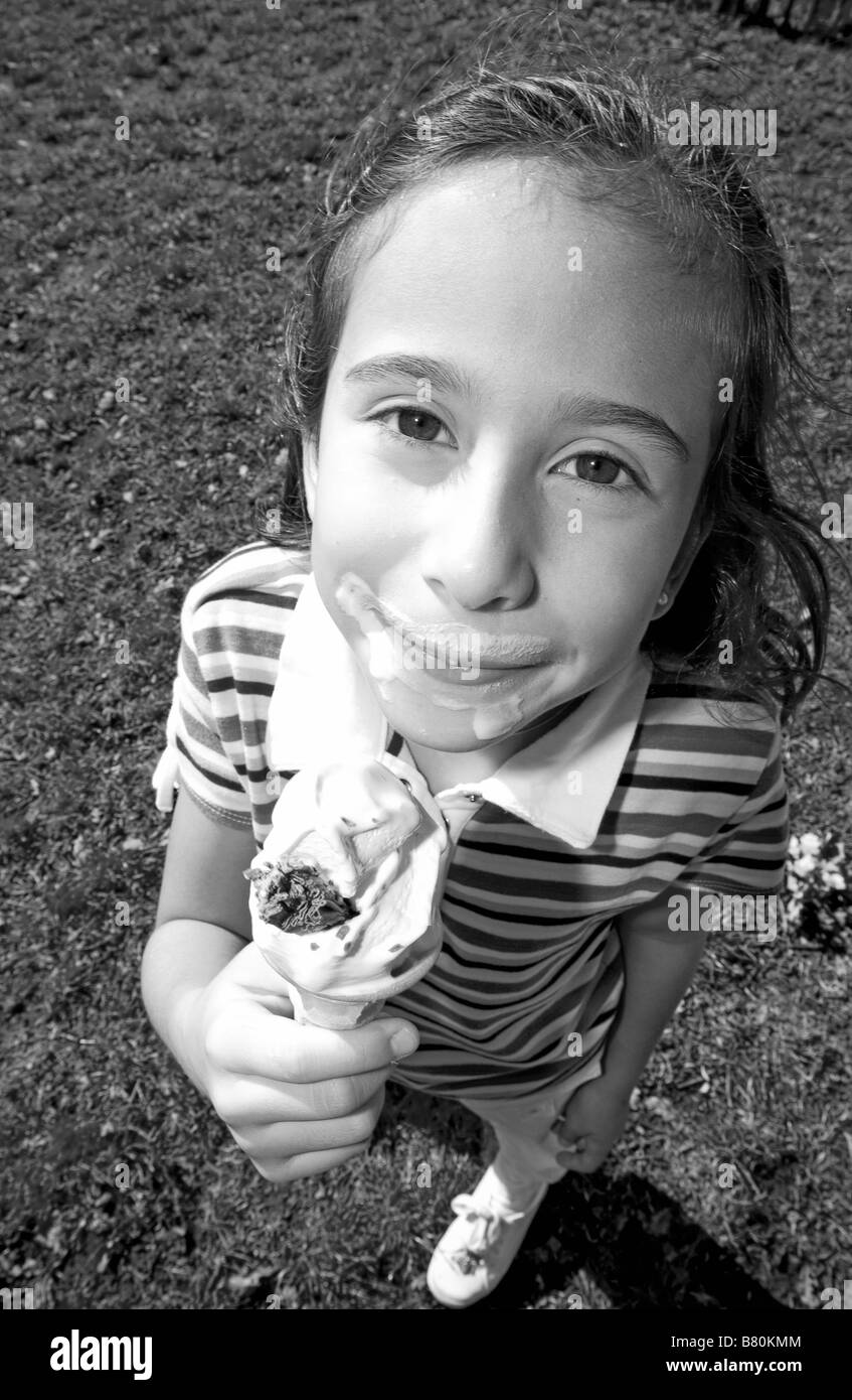 girl holding ice cream cone looking happy Stock Photo