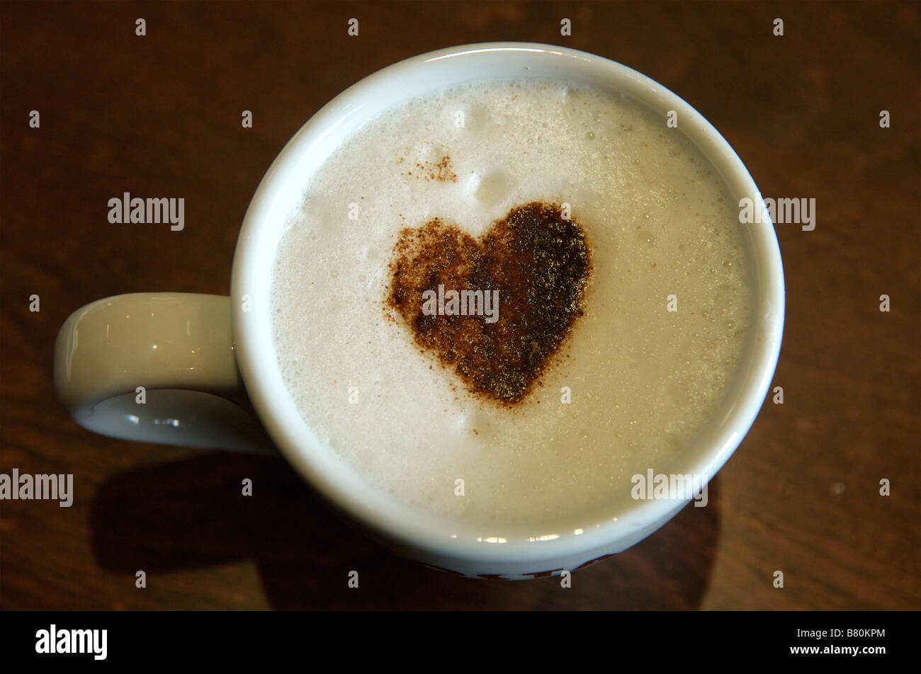 A hot coffee drink decorated with a love heart Stock Photo