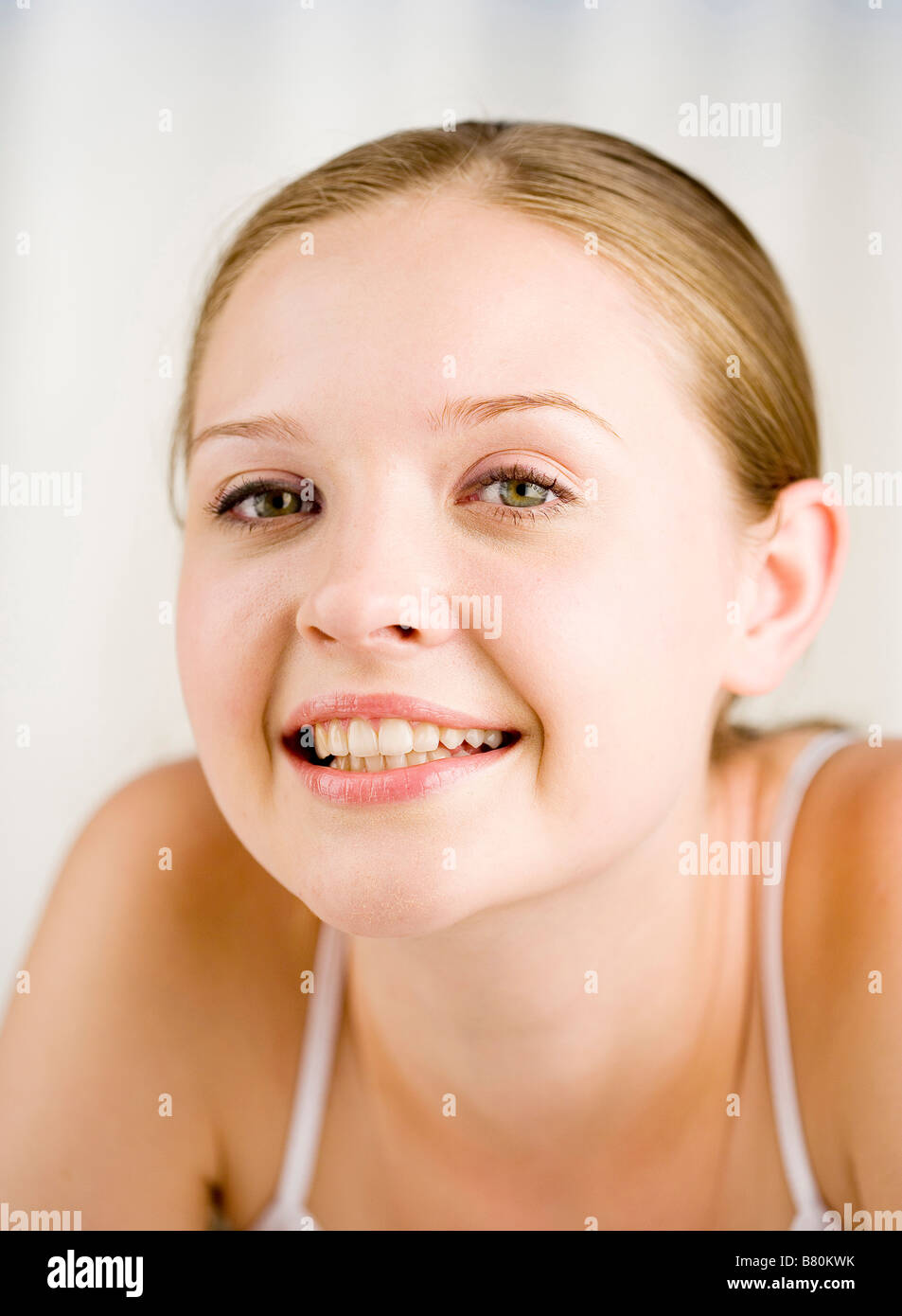 Close up to a young woman smiling looking at the camera Stock Photo