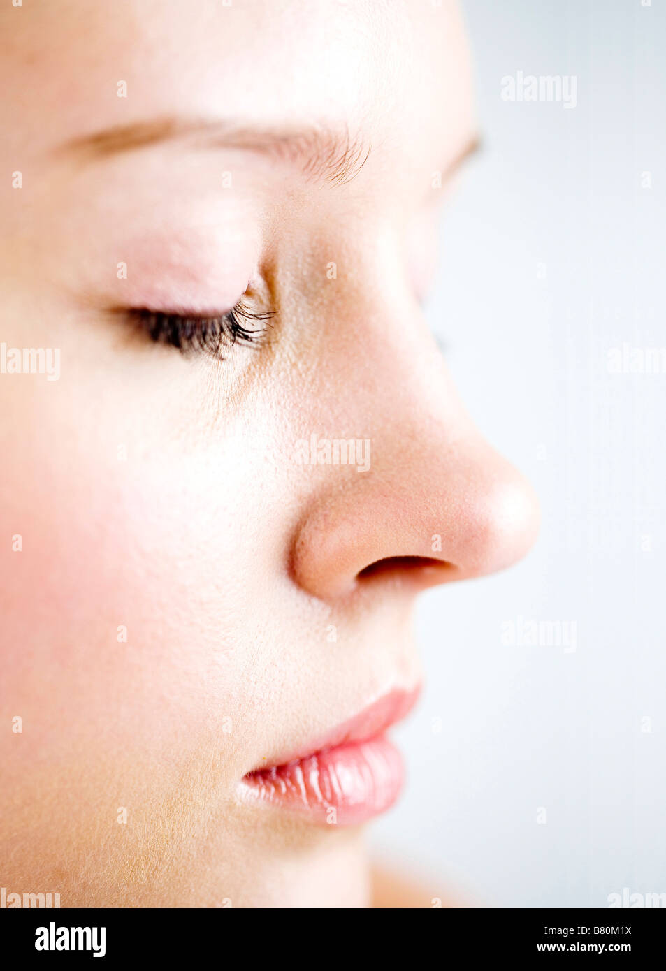 Close up to a young woman s right face side view eyes closed Stock