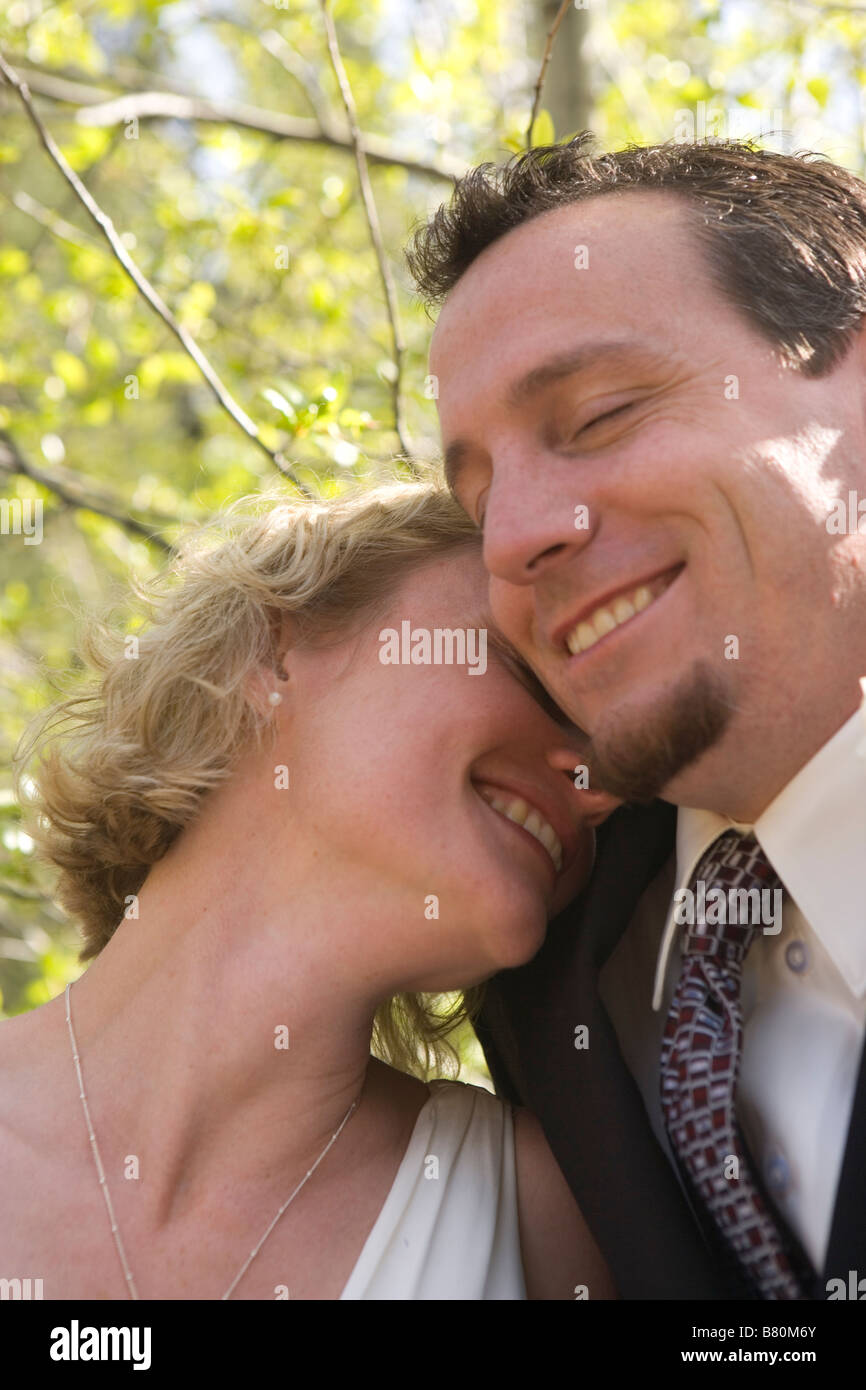 portrait of bride and groom smiling together outdoors after ceremony Stock Photo