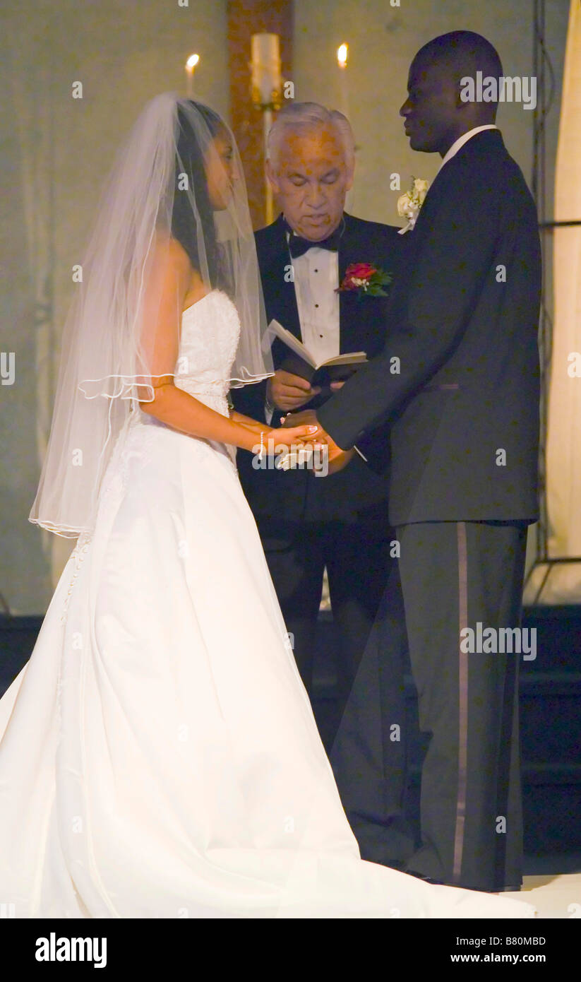 A white minister presides at the wedding of a mixed race bride and an
