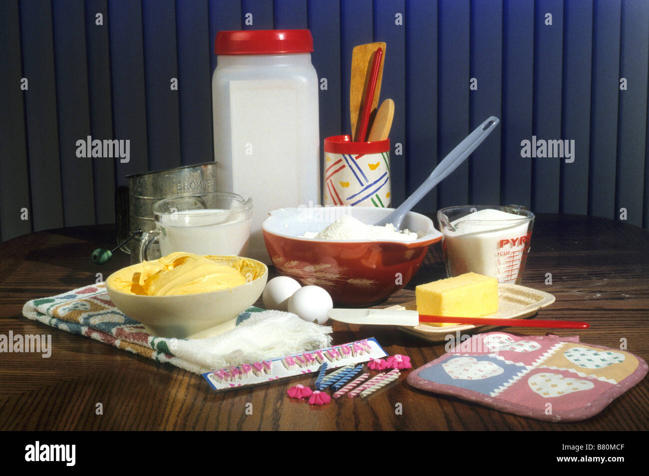 Materials needed to make birthday cake gathered on table Stock 