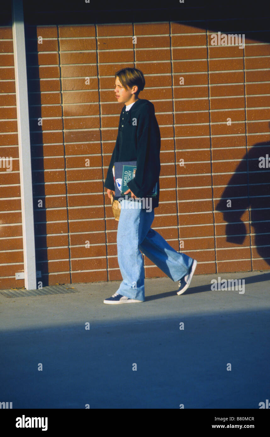 Teen boy arrives early to school. morning punctual time hour sunrise Stock Photo