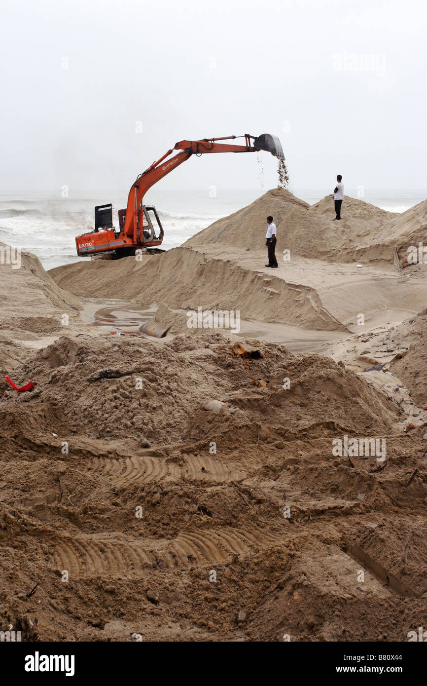 An excavator working on sandy beach in Terengganu, Malaysia Stock Photo ...