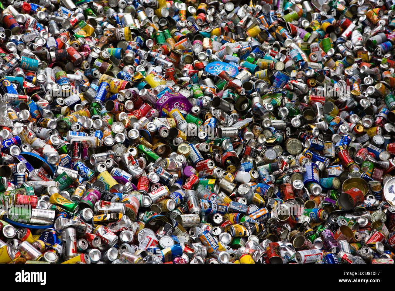 piles of used aluminium beer cans food cans and soft drinks containers