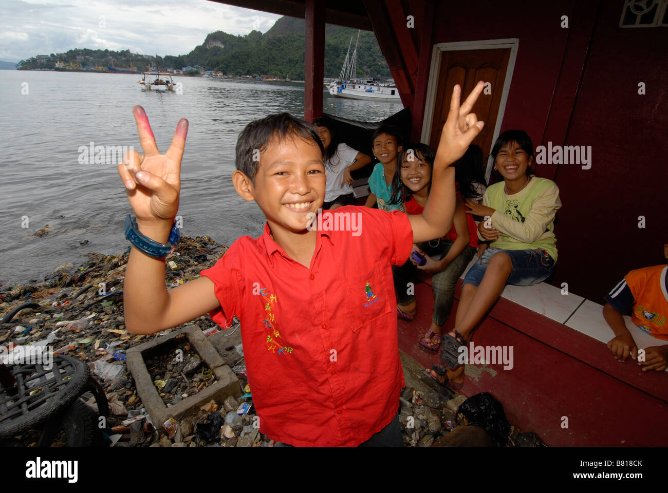 Family in poor neighbourhood at the waterfront of Jayapura, Indonesia. Stock Photo