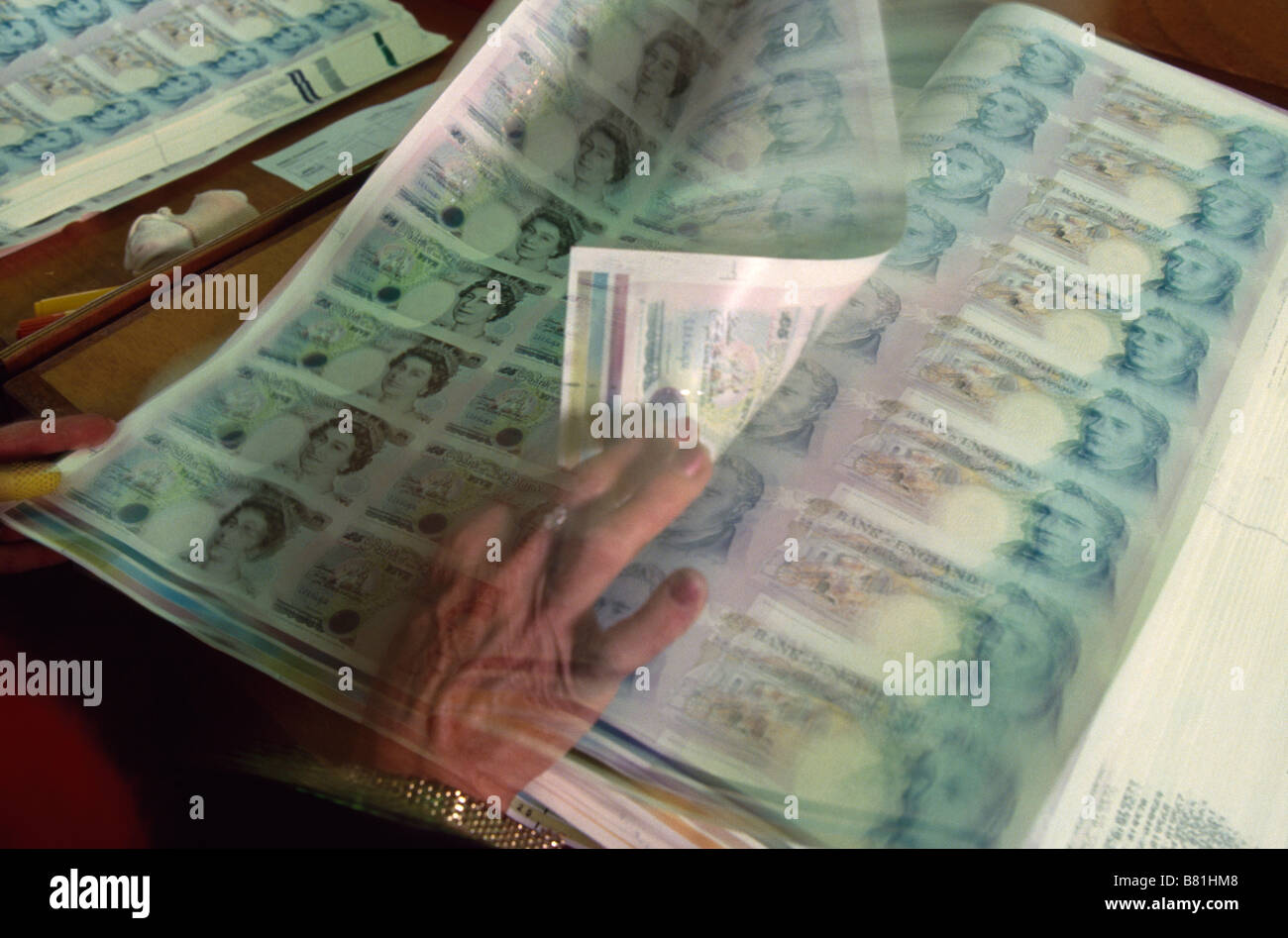 The Bank of England printing works, now De La Rue, in Debden Newly printed sheets of £5 notes are checked for printing mistakes Stock Photo