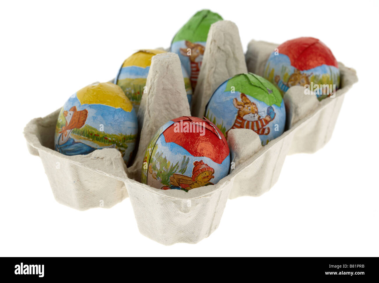 half dozen six small chocolate easter eggs wrapped up placed in an egg carton Stock Photo