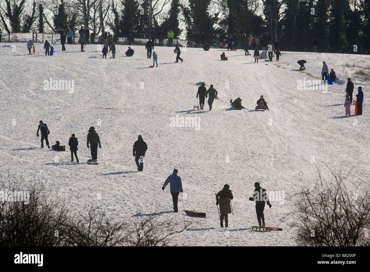 Snow on the Gog Magog Hills near Cambridge, Britain. Families enjoy the
