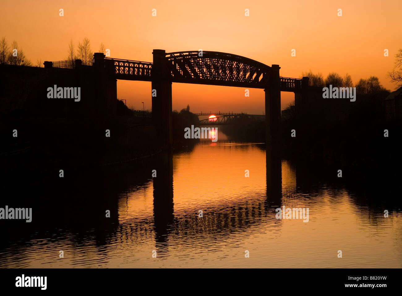 Manchester Ship Canal at sunset with Latchford Railway Viaduct in foreground, Warrington, Cheshire, England, UK, Europe Stock Photo