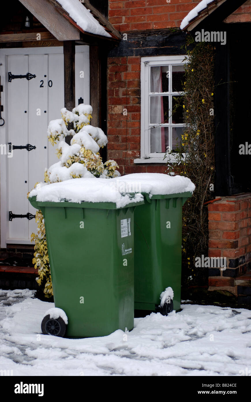 Recycling bins outside house, with snow on, UK Stock Photo Alamy
