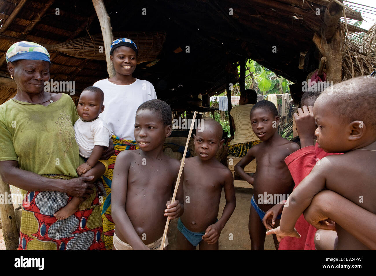 A family are happy to pose for a photograph in front of their home in a remote part of the jungle of Epe in Nigeria Stock Photo