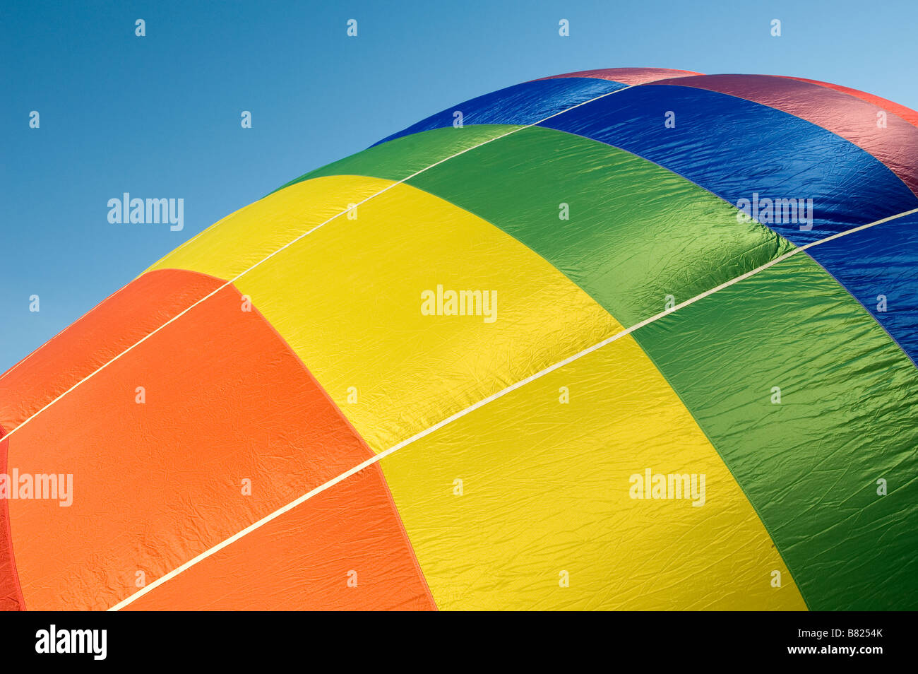Colourful hot air balloon against a bright blue sky Stock Photo - Alamy