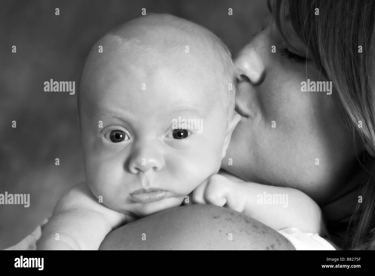 mother kissing baby portrait Stock Photo Alamy