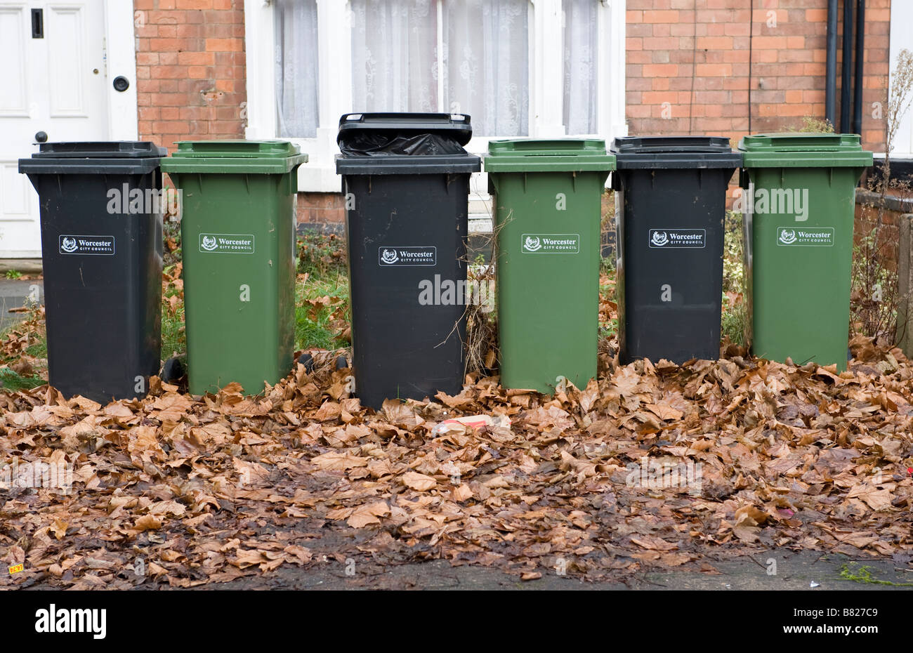 Domestic waste and recycling wheelie bins lined up outside houses in Worcestershire Stock Photo