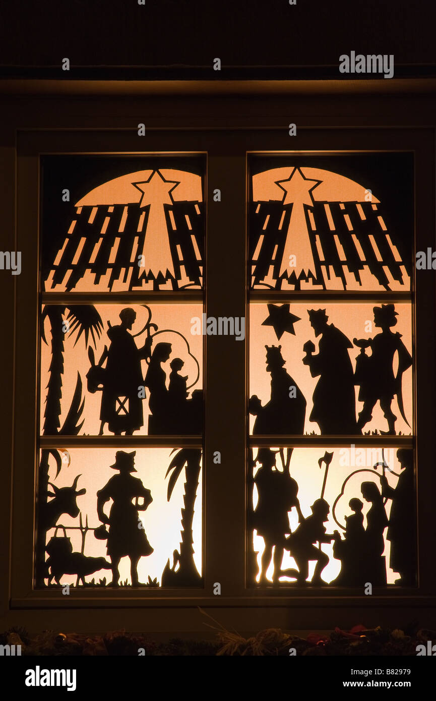ILLUMINATED CHRISTMAS WINDOW WITH NATIVITY SCENES DURING ADVENT TIME AT