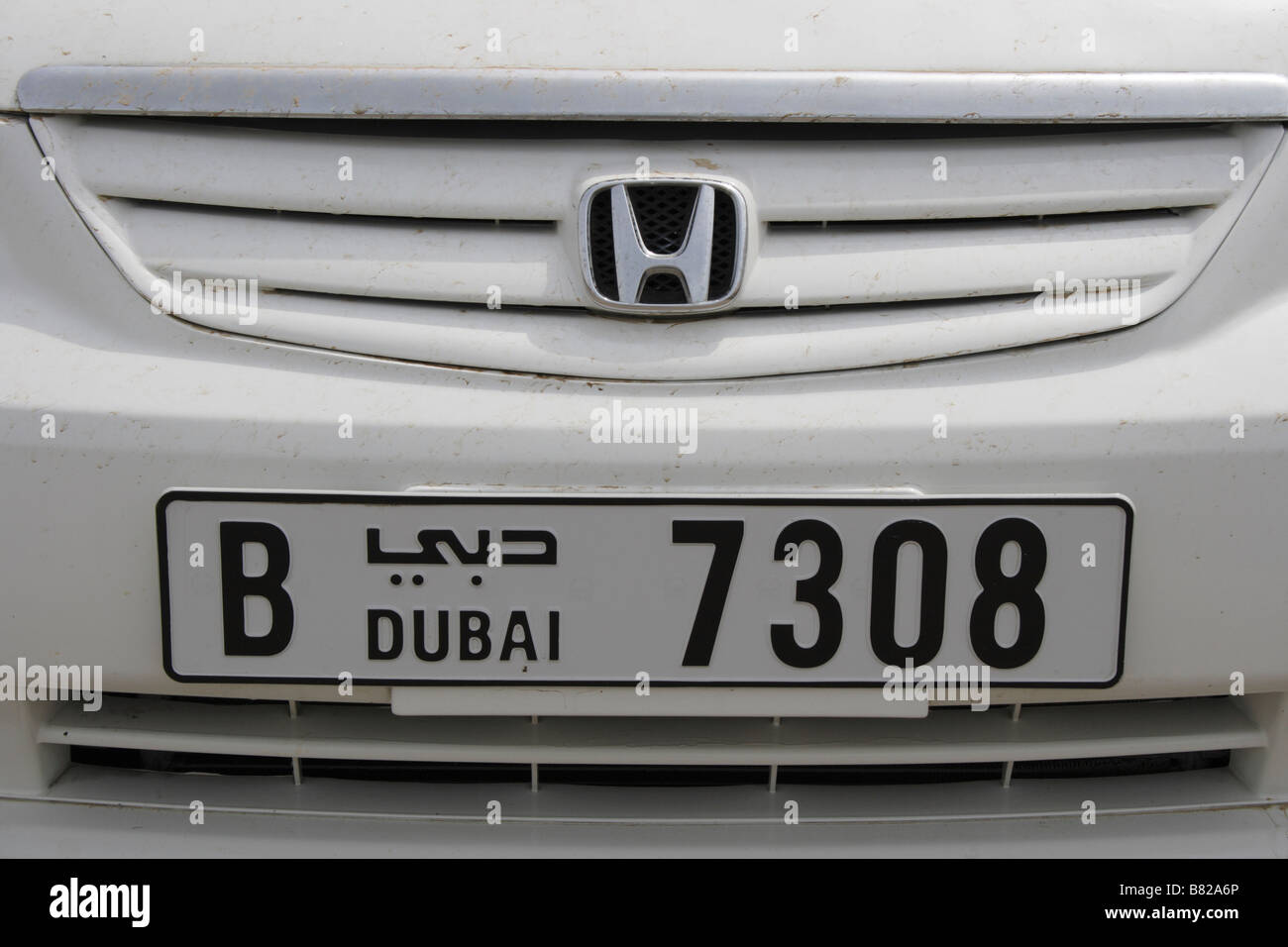 front of a white Honda car with Dubai license plate. Photo by Willy Matheisl Stock Photo