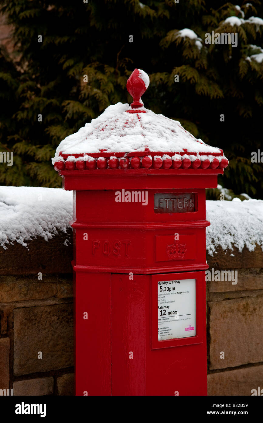 Snow covered Red Royal Mail post pillar box, Edinburgh, Scotland, UK, Europe Stock Photo