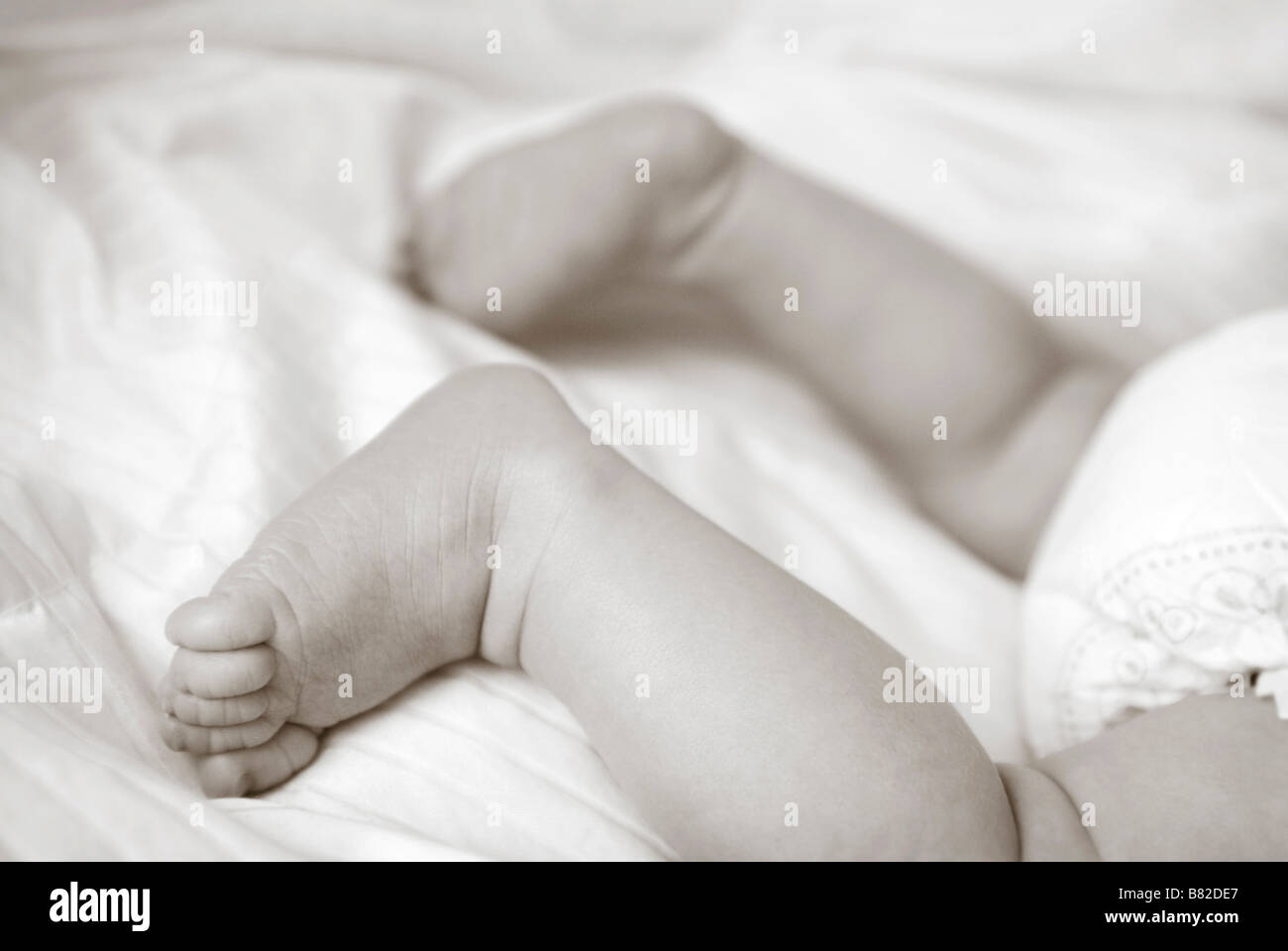 close up of baby's feet and baby bottom Stock Photo