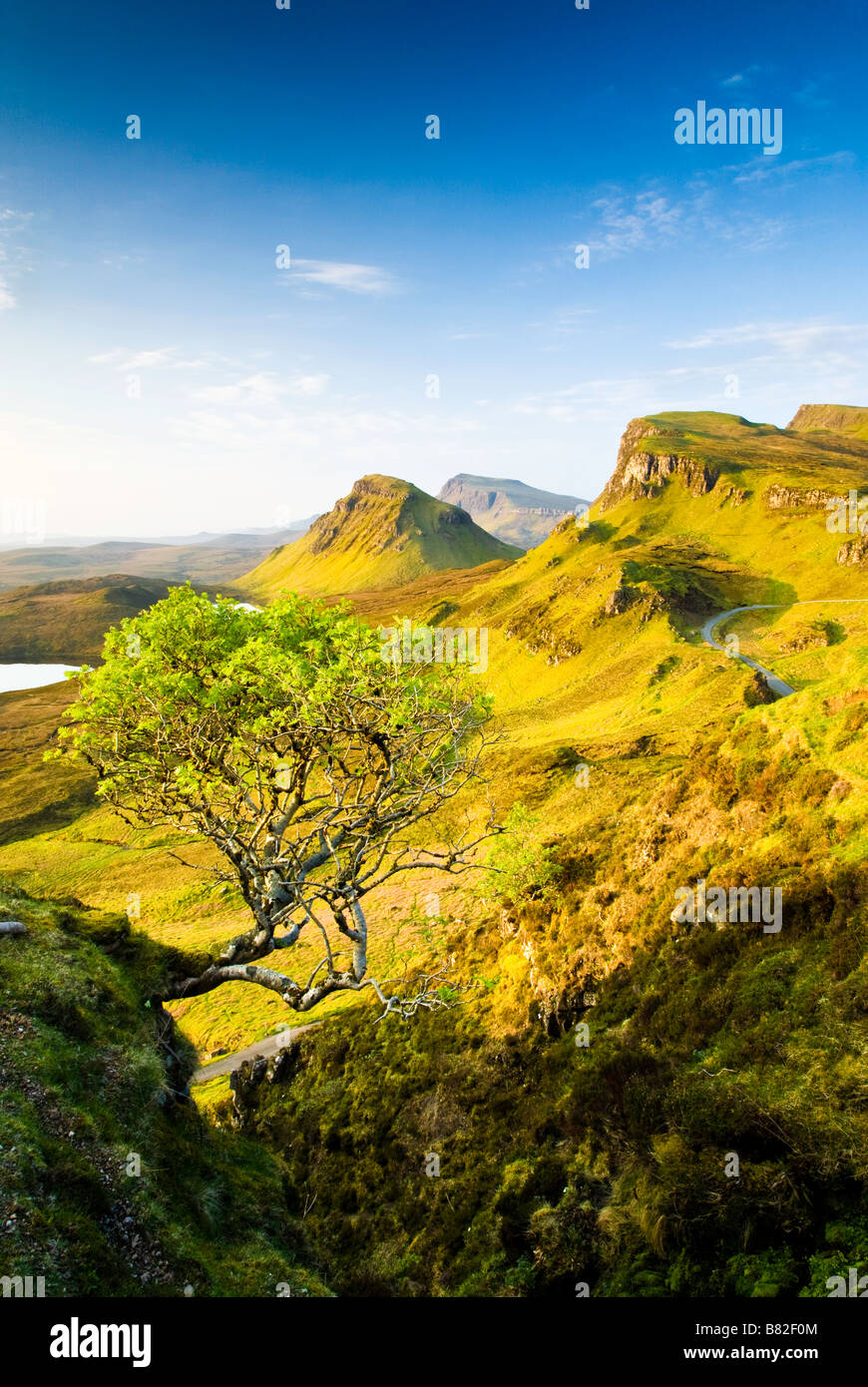 The Quiraing on the Isle of Skye in early May as the sun rises and paints the landscape in a lovely warm glow Stock Photo