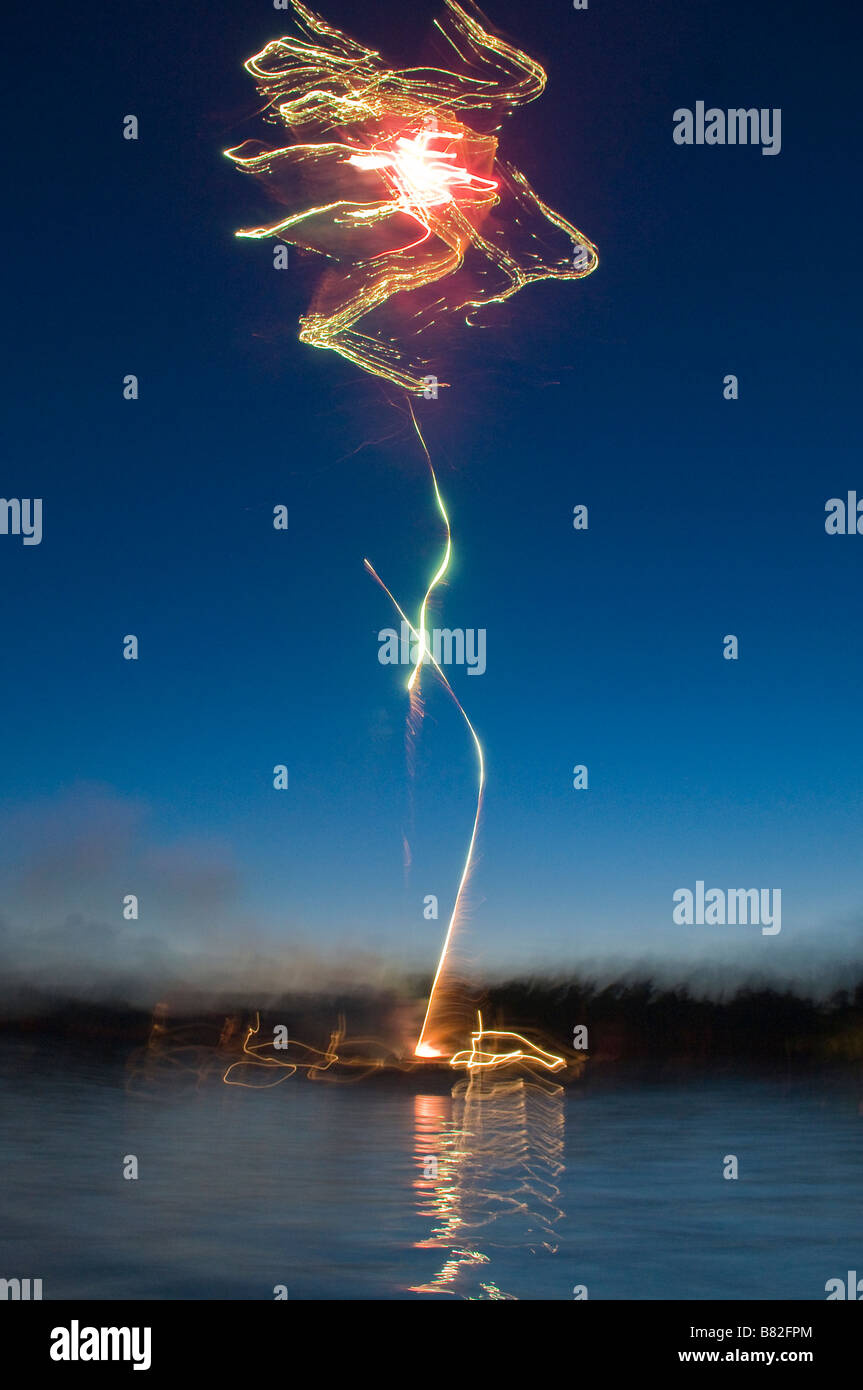 July Fourth fireworks time exposure Big Pine Lake Minnesota Stock Photo