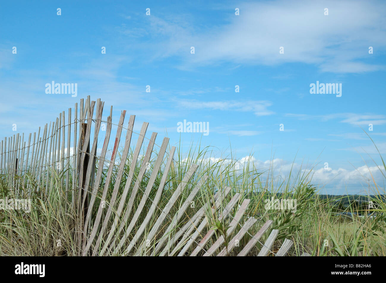 Sand dunes and fence at Misquamicut State Beach in Westerly Rhode Island USA with copy space Stock Photo