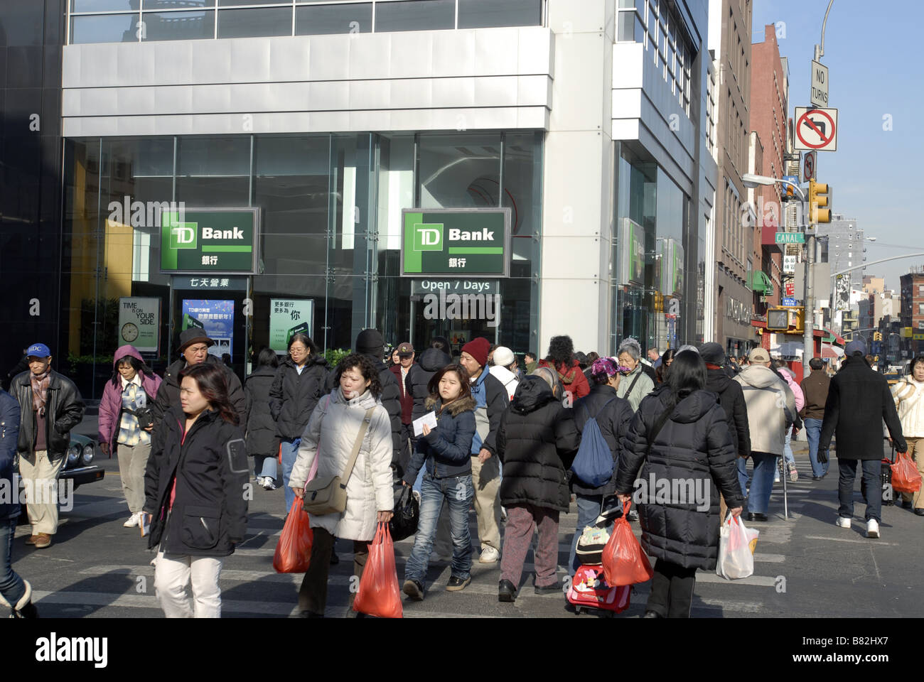 Pedestrians cross Canal Street in front of a branch of TD ...