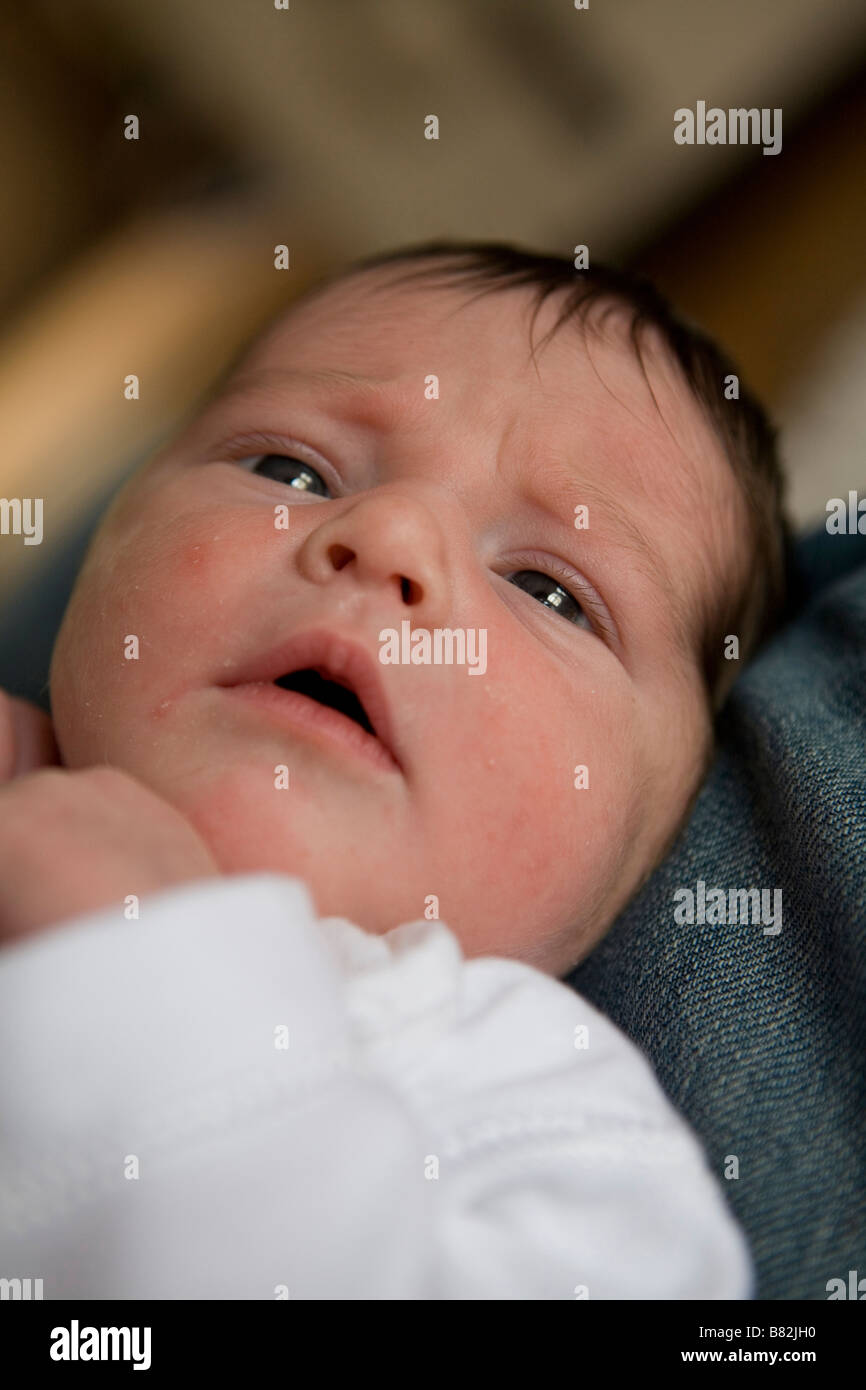 A newborn baby looking upwards . Stock Photo
