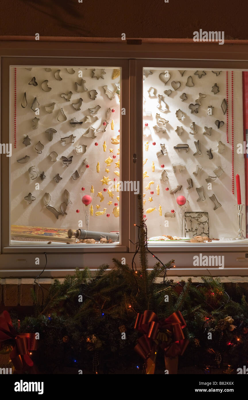 Illuminated Christmas Window Decorated With Cake Tins During