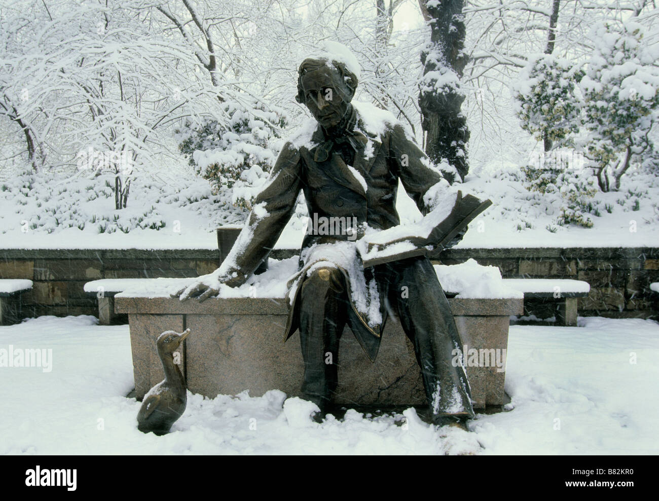 USA New York New York City Central Park Statue of Hans Christian Anderson and the Ugly Duckling in a Snowstorm Stock Photo