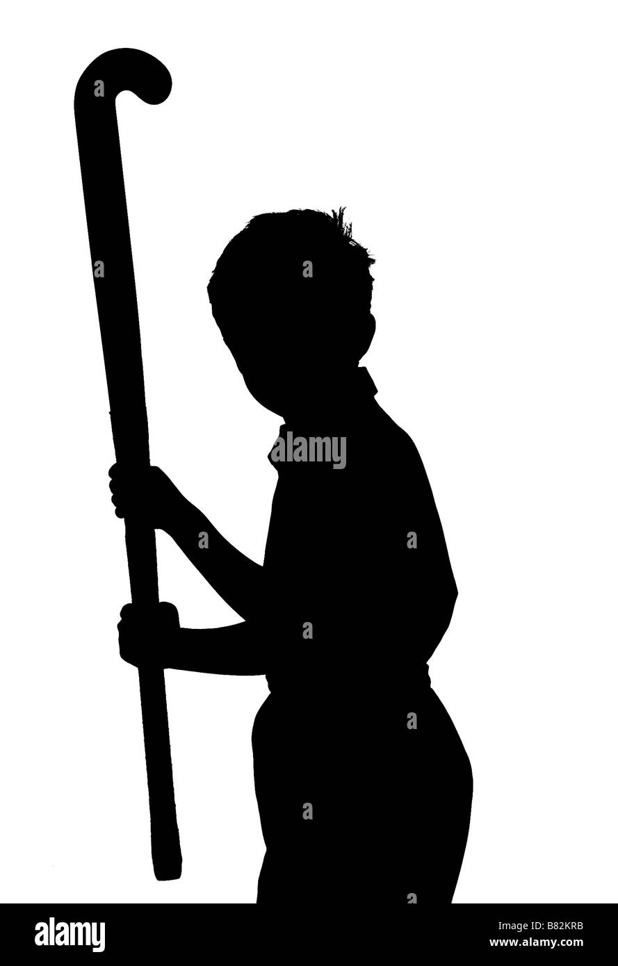 silhouette of boy ho ding a hockey stick Stock Photo