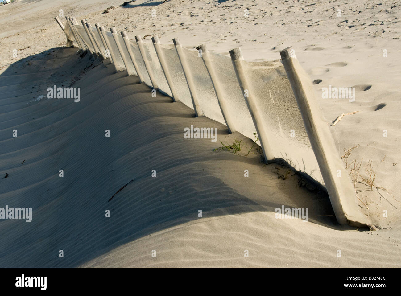 Fence posts on sandy hill Stock Photo Alamy