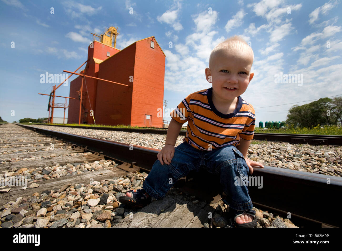 Boy on railroad tracks; Lake Lenore, Saskatchewan, Canada Stock Photo