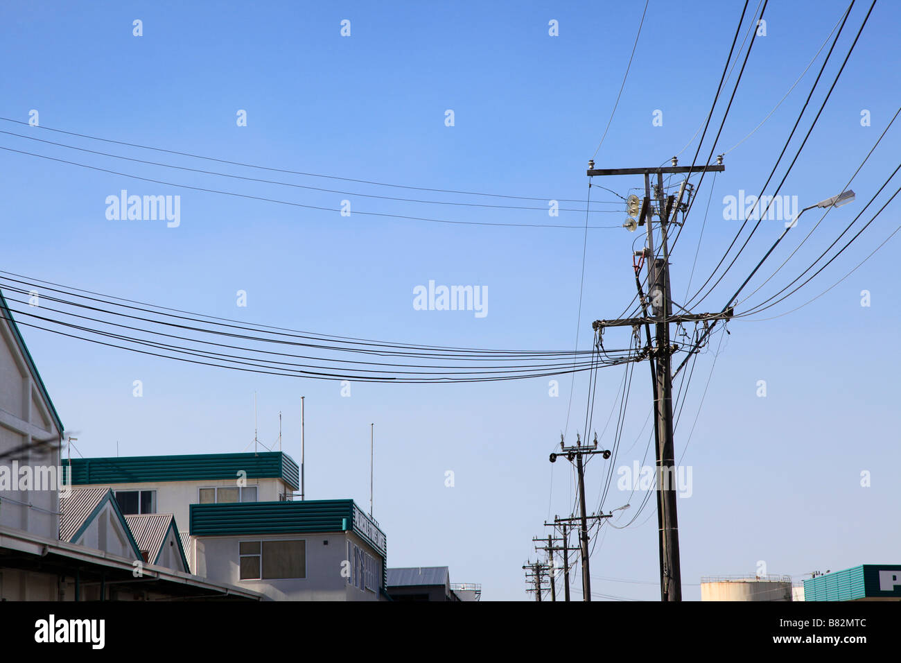 Power line and wooden poles in industrial road,Timaru,Canterbury,South Island,New Zealand Stock Photo
