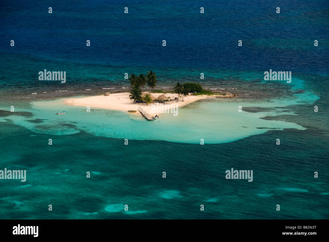 Aerial view Belize coral reefs and island, atoll, paradise, tropical island, palm trees, white sand, blue water, clear water Stock Photo