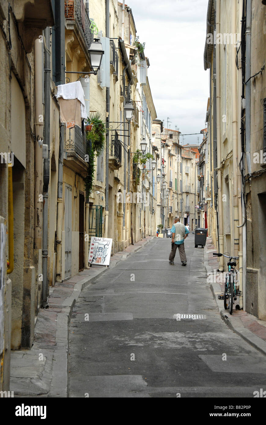 Man in a quiet alley of the historic old town of Montpellier, Languedoc Roussillon, France, Europe Stock Photo