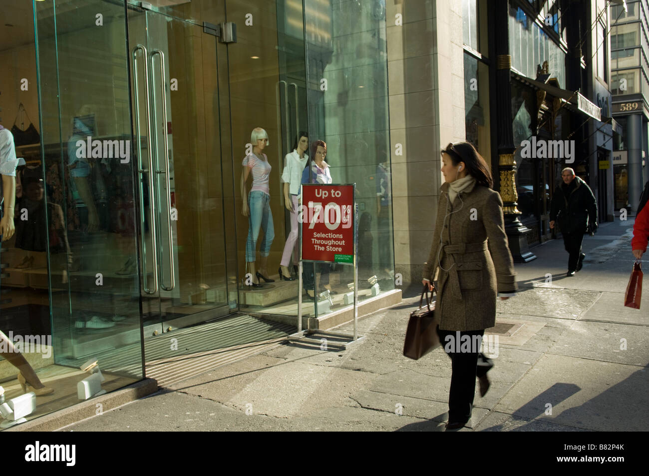 A pedestrian passes a store on Fifth Avenue in the midtown