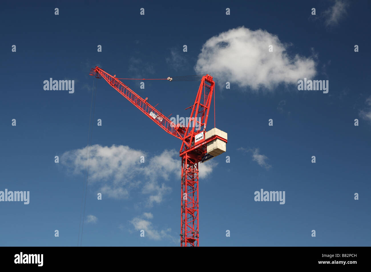 A construction crane against a blue sky Stock Photo - Alamy