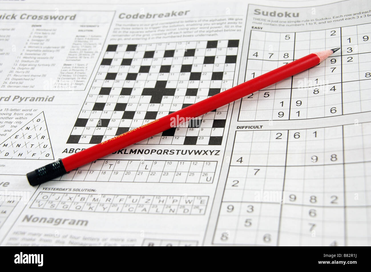 A newspaper page with a variety of word and number puzzles. Stock Photo